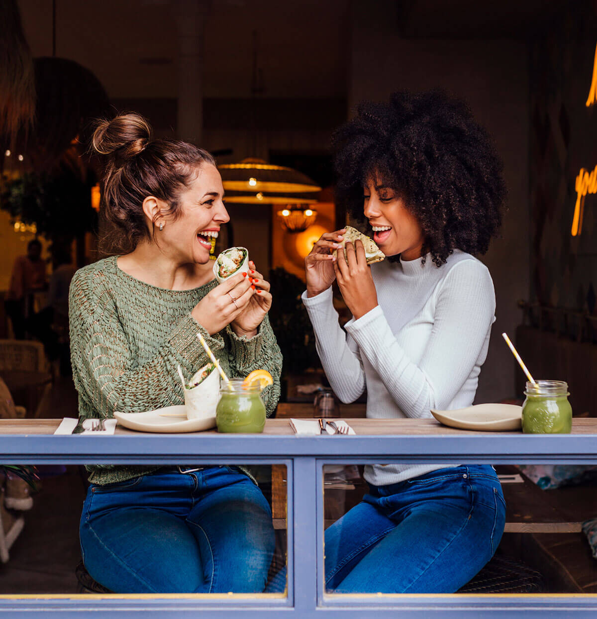 Two friends enjoy a meal together at a restaurant