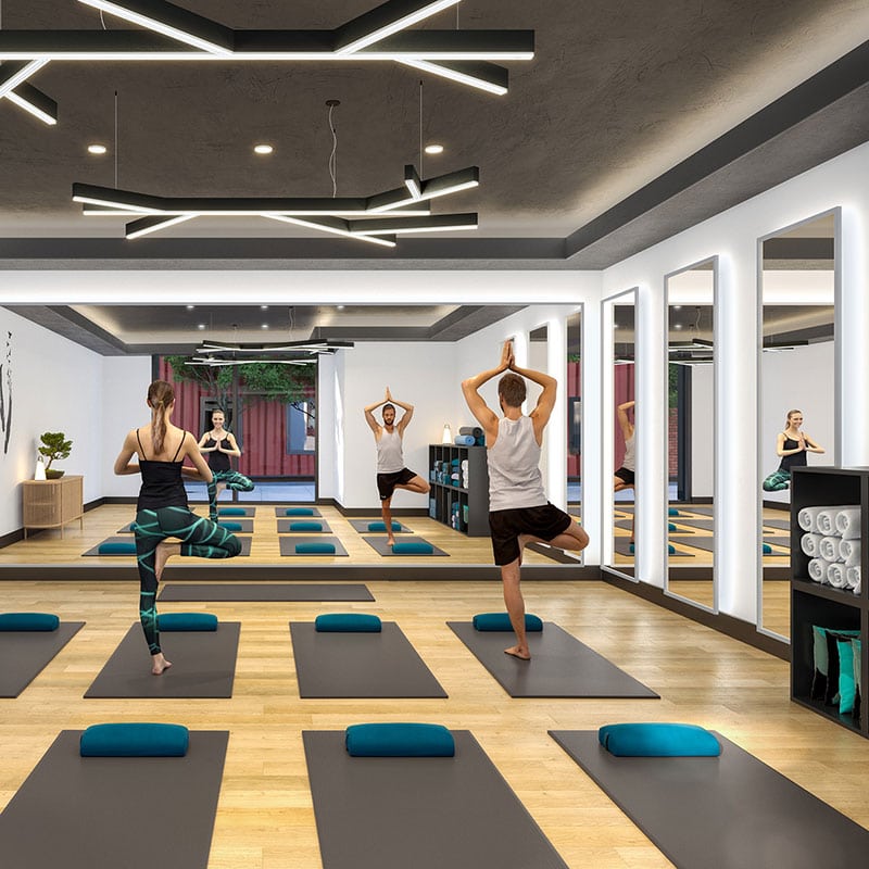 Two people use an indoor yoga studio